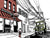 Illustrated silkscreen art print of Sunny’s Bar in Red Hook, Brooklyn by John Tebeau, featuring the bar’s facade, cobblestone street, old truck, electrical wires, red and green accent colors